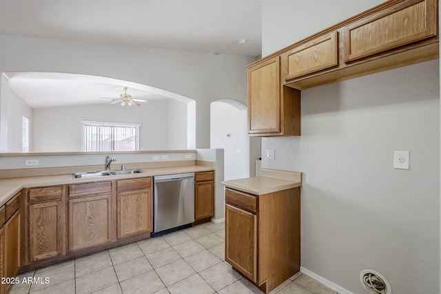 16077 W Larkspur Dr, Goodyear, AZ 85338 - kitchen with dishwasher, a sink, arched walkways, ceiling fan, and brown cabinets