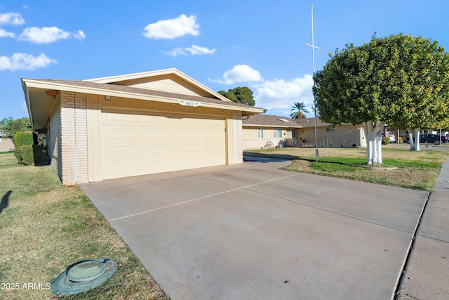 ranch-style home with a garage and a front yard