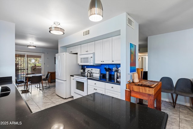 kitchen featuring white appliances, white cabinetry, and light tile patterned flooring