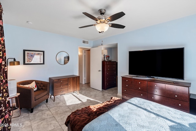 tiled bedroom featuring ceiling fan