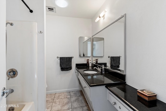 bathroom with shower / tub combination, vanity, and tile patterned floors