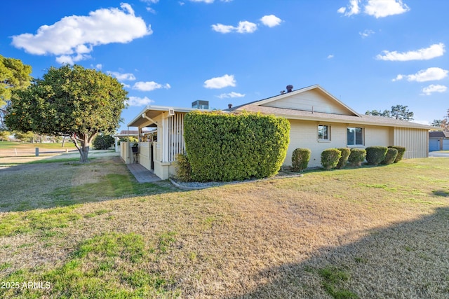 view of side of property with a yard