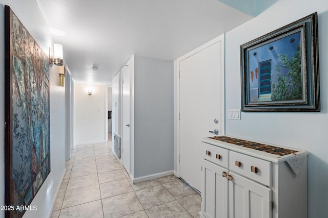 hall featuring light tile patterned flooring