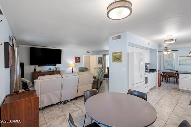 dining space with ceiling fan and light tile patterned floors