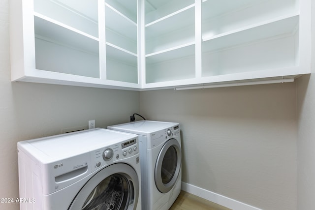 laundry room with light hardwood / wood-style floors and separate washer and dryer