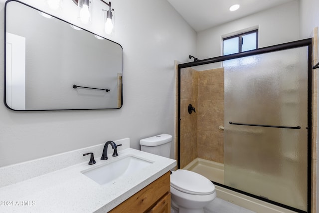 bathroom featuring vanity, toilet, and walk in shower