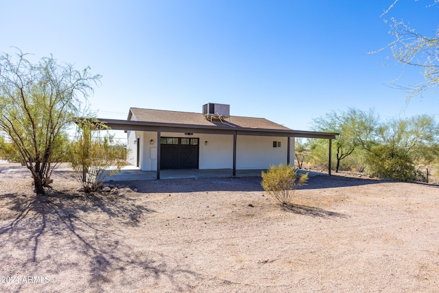 back of property featuring central AC