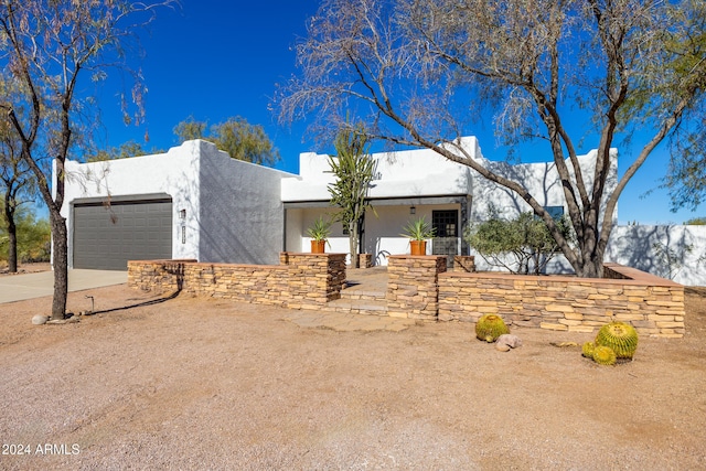 southwest-style home with a garage