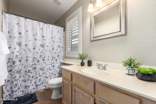 bathroom featuring tile patterned flooring, vanity, and toilet