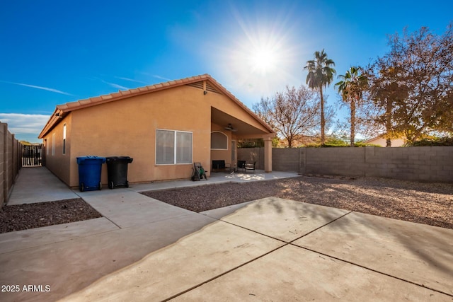 back of house featuring ceiling fan and a patio area