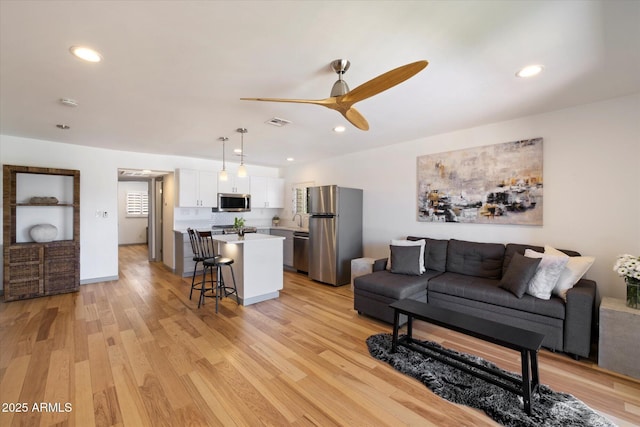 7430 E Chaparral Rd Unit A222, Scottsdale, AZ 85250 - living area featuring ceiling fan, light wood-type flooring, and recessed lighting