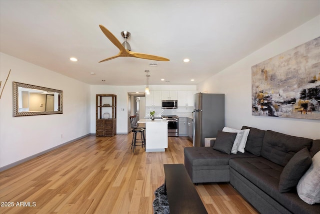 7430 E Chaparral Rd Unit A222, Scottsdale, AZ 85250 - living room with light wood-type flooring, ceiling fan, and recessed lighting