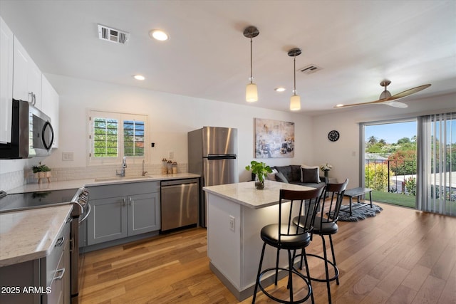 7430 E Chaparral Rd Unit A222, Scottsdale, AZ 85250 - kitchen with appliances with stainless steel finishes, a sink, healthy amount of natural light, light wood finished floors, and recessed lighting