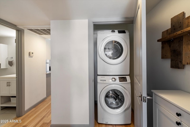 7430 E Chaparral Rd Unit A222, Scottsdale, AZ 85250 - laundry area with stacked washer and clothes dryer and light wood-style flooring
