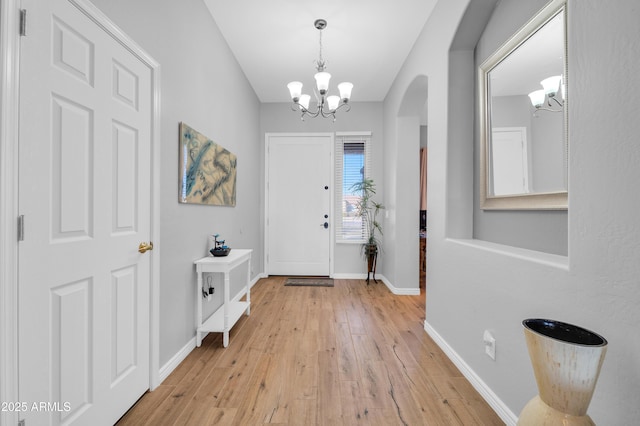 foyer featuring light hardwood / wood-style flooring and a notable chandelier