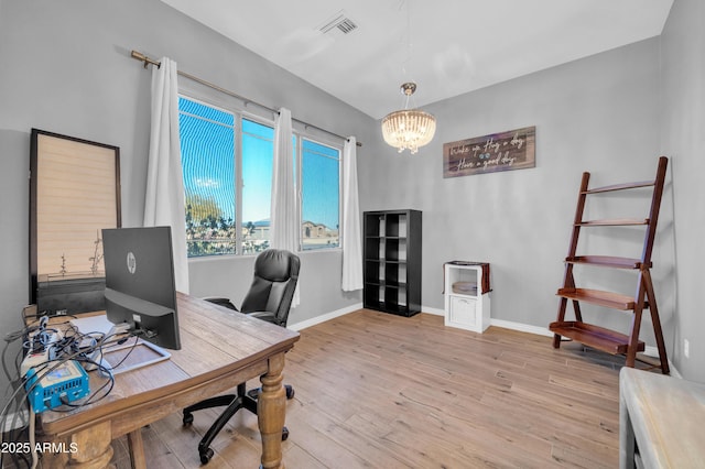 office area featuring a notable chandelier and light hardwood / wood-style flooring