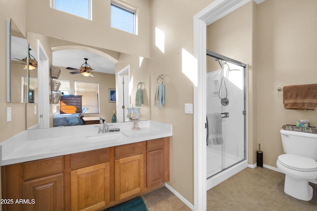 bathroom with vanity, walk in shower, ceiling fan, toilet, and tile patterned floors