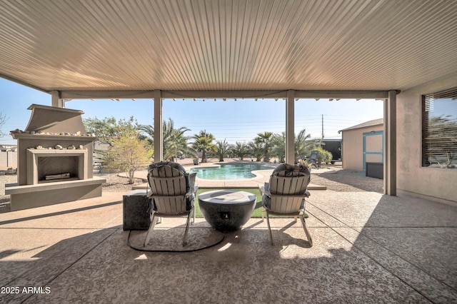 view of patio with exterior fireplace