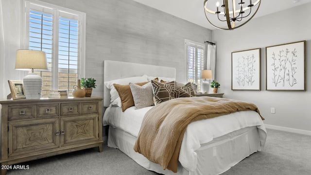 bedroom featuring light colored carpet, a chandelier, and baseboards