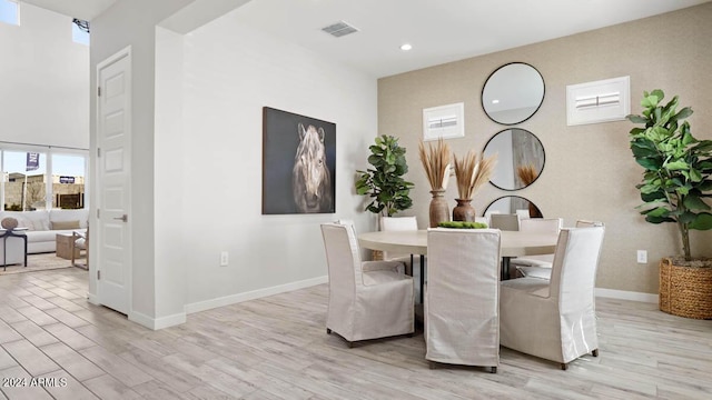dining room with light wood-type flooring, visible vents, baseboards, and recessed lighting