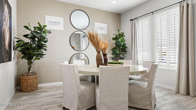 dining room with wood finished floors, baseboards, and recessed lighting