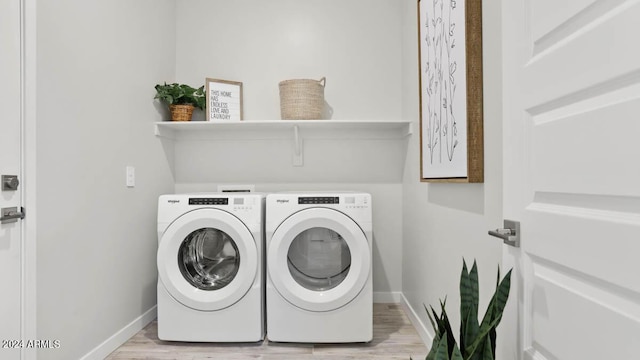 clothes washing area featuring laundry area, light wood-style flooring, baseboards, and independent washer and dryer