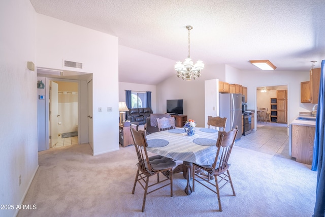 17810 N 34th Pl, Phoenix, AZ 85032 - dining space featuring light colored carpet, a chandelier, a textured ceiling, and lofted ceiling