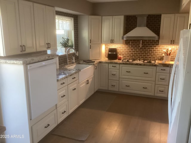 1036 E Wagon Wheel Dr, Phoenix, AZ 85020 - kitchen with white appliances, wall chimney range hood, white cabinets, decorative backsplash, and light stone countertops