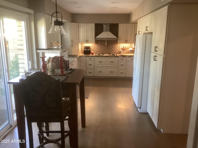 1036 E Wagon Wheel Dr, Phoenix, AZ 85020 - kitchen featuring wall chimney range hood, freestanding refrigerator, plenty of natural light, and decorative backsplash