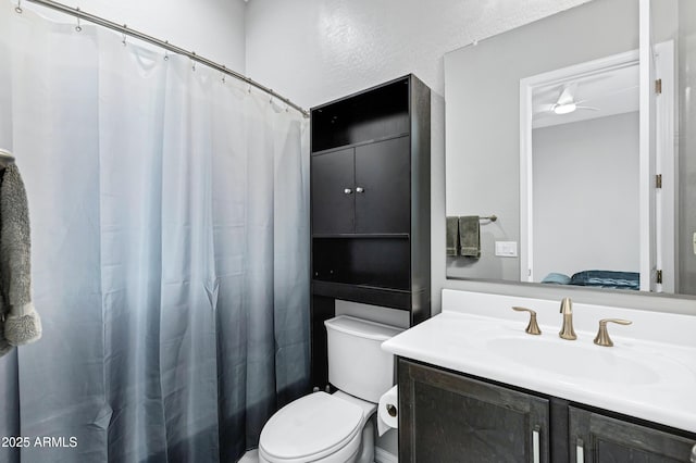 full bath with toilet, curtained shower, and vanity