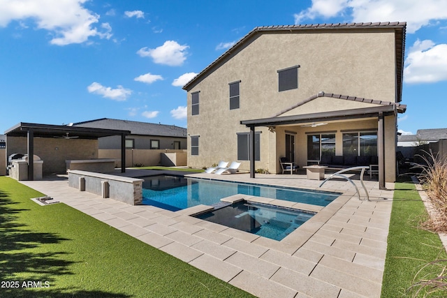 view of swimming pool with a patio, exterior kitchen, a fenced backyard, and a ceiling fan