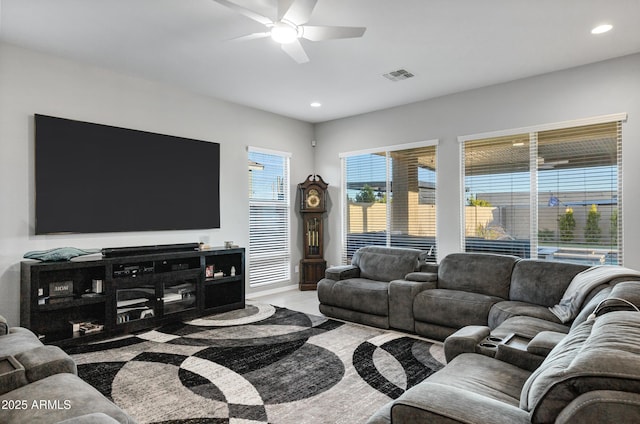 living area with a ceiling fan, recessed lighting, and visible vents