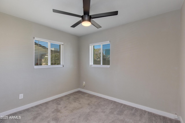 spare room featuring baseboards, ceiling fan, and light carpet