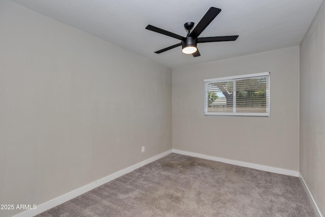 spare room with carpet flooring, a ceiling fan, and baseboards