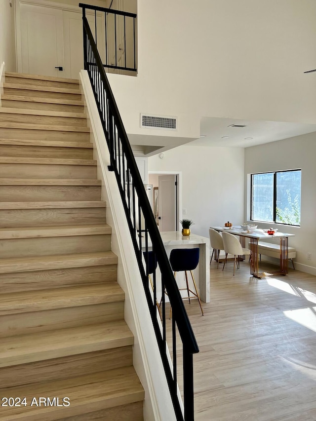 stairway with hardwood / wood-style flooring