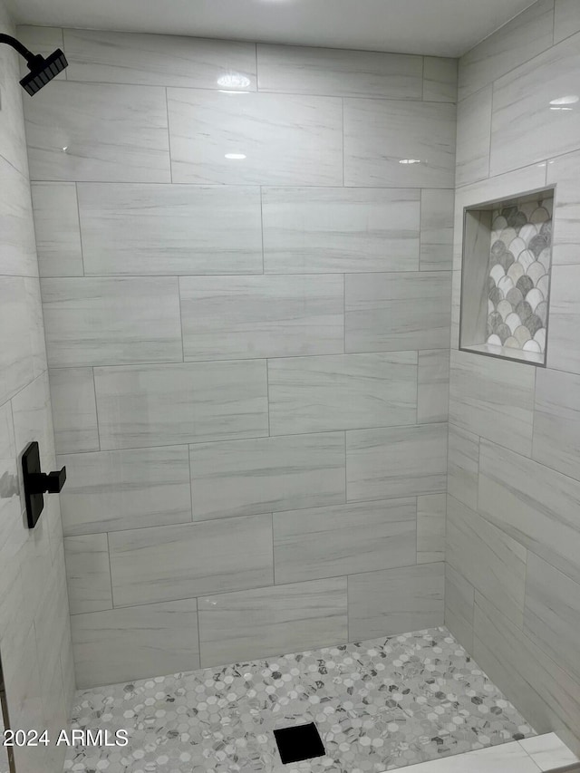 bathroom with a tile shower