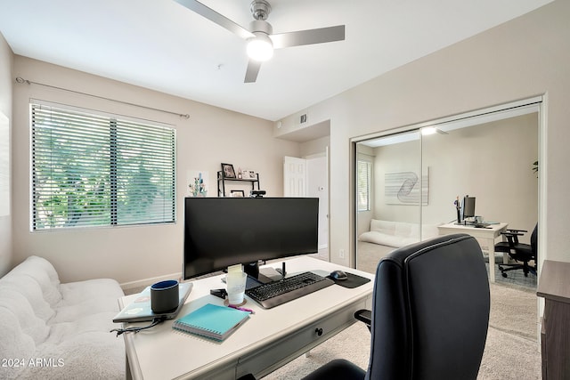 carpeted office featuring ceiling fan