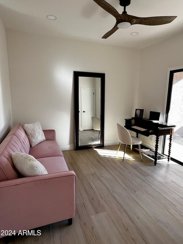 office with light hardwood / wood-style flooring and ceiling fan