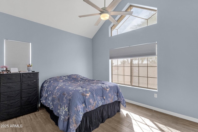 bedroom featuring ceiling fan, high vaulted ceiling, and light hardwood / wood-style floors