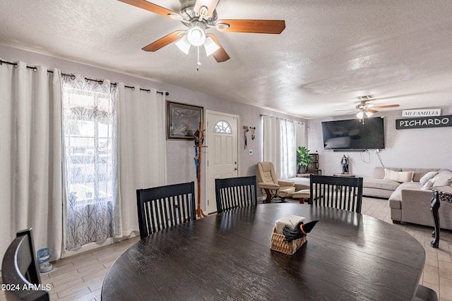 dining space featuring a textured ceiling and ceiling fan