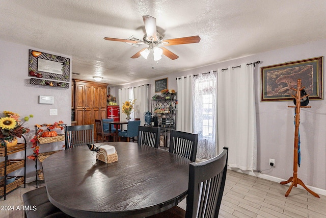 dining space with a textured ceiling and ceiling fan