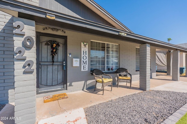 view of exterior entry with covered porch