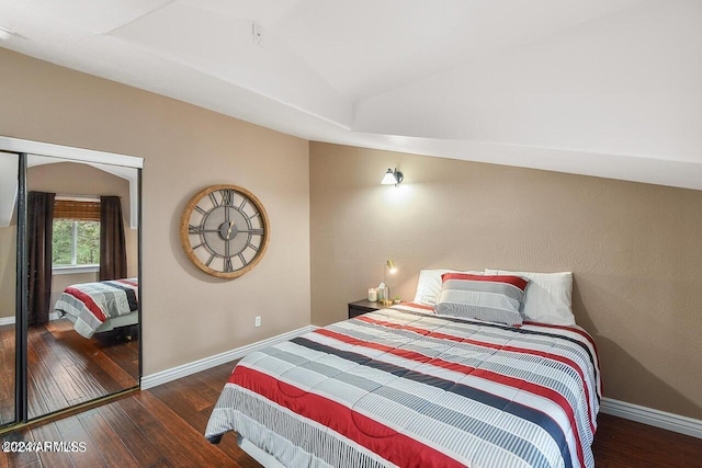 bedroom featuring lofted ceiling and dark hardwood / wood-style flooring