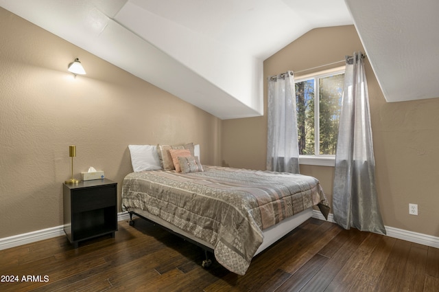 bedroom featuring vaulted ceiling and dark hardwood / wood-style flooring