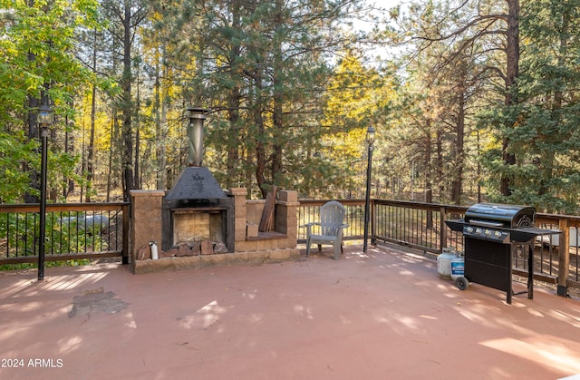 view of patio with an outdoor fireplace and grilling area