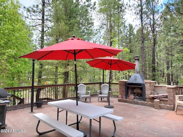 view of patio featuring area for grilling and an outdoor stone fireplace