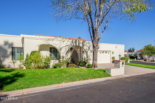 view of front of house with a garage and a front yard