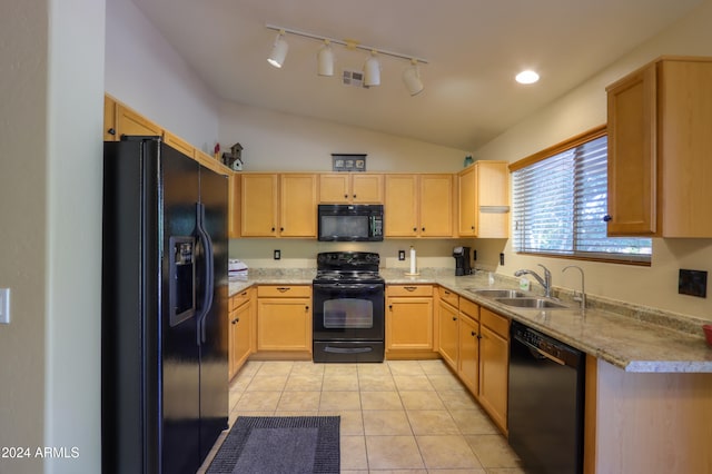 kitchen with black appliances, sink, vaulted ceiling, light tile patterned floors, and light brown cabinetry