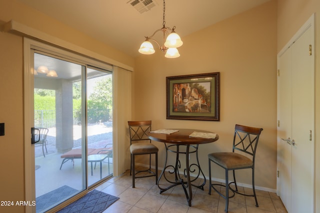 tiled dining space featuring a notable chandelier