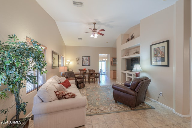 living room with built in shelves, light tile patterned floors, ceiling fan, and lofted ceiling